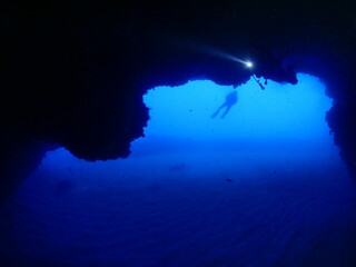 Fototapeta na wymiar cave diving underwater scuba divers exploring caves and having fun ocean scenery sun beams and rays background