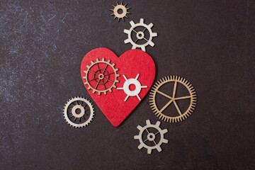 Gear wheels on red Heart shape. Valentine concept and promise of love.