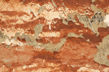 Authentic red gray background with pink tints. Wooden planks under weathered plaster of the...