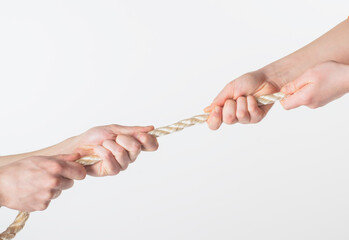
male and female hands pull the rope on a white background close-up