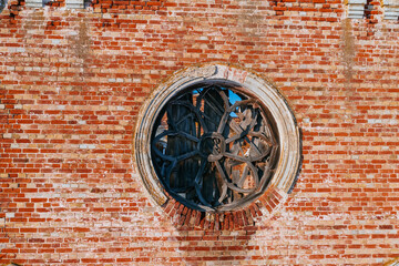 Round broken stained glass window in old abandoned church