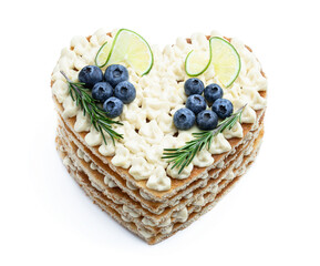 Homemade Heart shaped layered cake decorated with lime and blueberry isolated on white