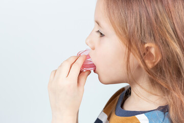 Adorable little girl puts myofunctional trainer in the mouth