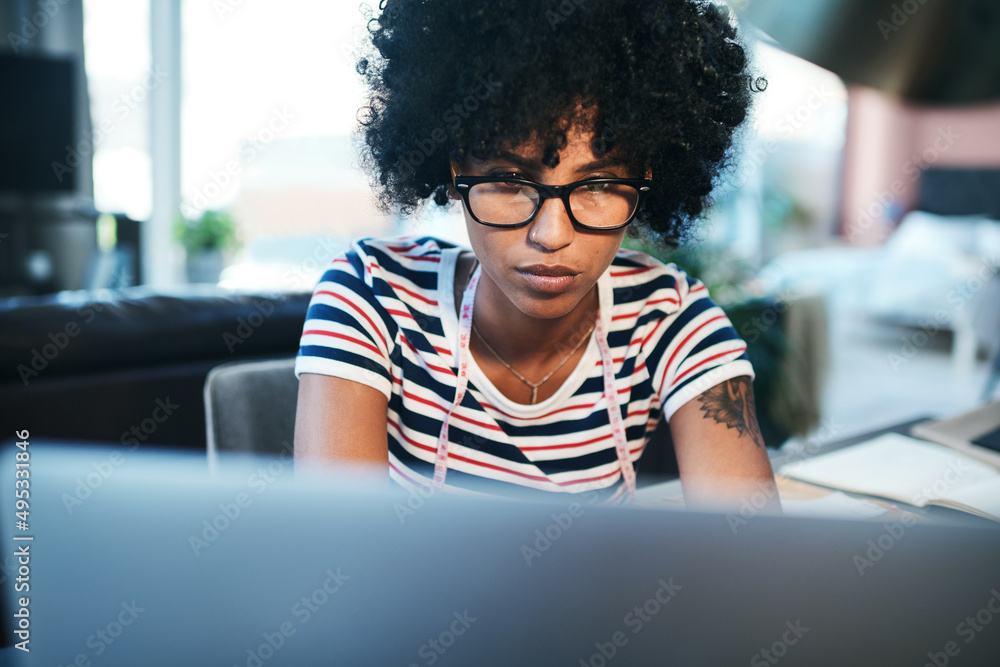 Poster put in the work and watch your business grow. shot of a young designer using her laptop while workin
