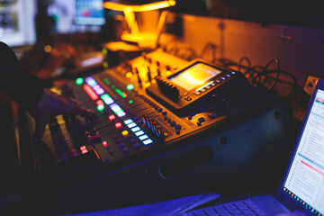 View of lighting technician operator working on mixing console workplace during live event concert...