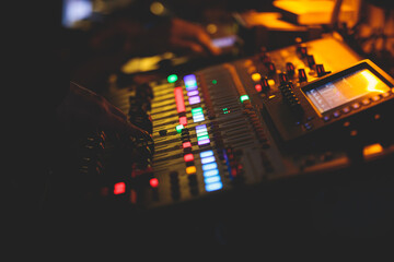 View of lighting technician operator working on mixing console workplace during live event concert on stage show broadcast, light mixer controller panel, sound technician with professional equipment