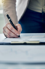 Fototapeta premium Signing the deal of the century. Shot of an anonymous businessperson filling out paperwork.
