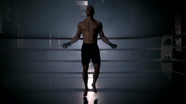 Boxer jumping rope in boxing ring. High quality 4k footage