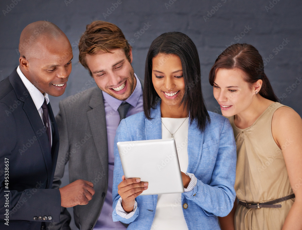 Poster analyzing the figures. shot of a group of businesspeople working over a digital tablet.