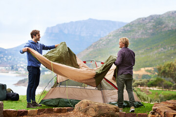 Camping is great fun. Shot of a two male friends at the campsite.