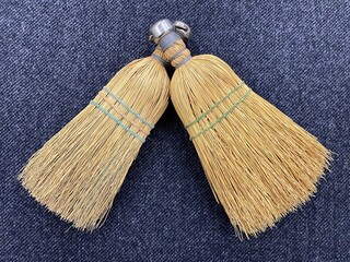 Two small brooms. Device for cleaning apartment and sweeping floor. Concept of cleanliness and...