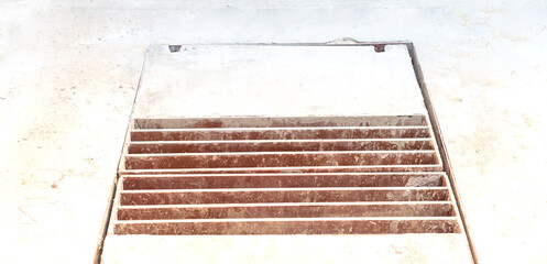 Rusty metal manhole cover opening on construction urban road, It’s dangerous for people in the construction area.