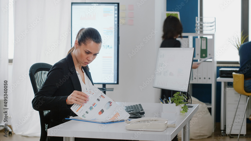 Poster business manager checking data charts with files and computer for strategy planning and analysis. en