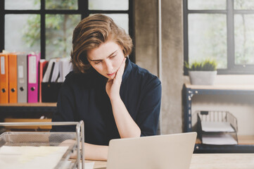 Businesswoman seriously working on computer laptop in office. She thinking find solution problem of work