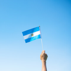 hand holding Argentina flag on nature background. 9th July of Independence day, 25th May of...