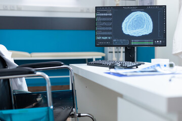 Computer standing on table having brain ct-scan on screen during oncology examination. Empty hospital office equipped with medical professional instruments. Health care services support