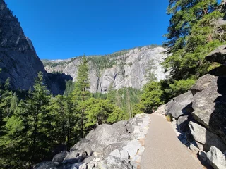 Foto op Canvas The start of the Mist trail is paved up to Vernal Falls footbridge at Yosemite National Park © Salil