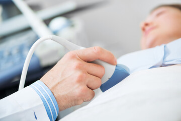 Doctor doing ultrasound screening checkup - 495343235