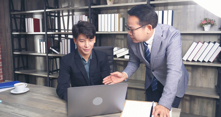 Businessman mentor coworker at office desk as team leader bossy manager. Two business people talking together start up new project planning strategy office meeting room. Businessman discuss, planning