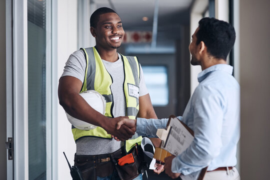 Well See You On Monday. Shot Of Two Young Architects Standing Together And Shaking Hands After A Discussion About The Room Before They Renovate.