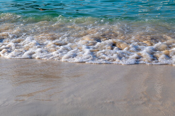 sandy seashore and big waves in summer