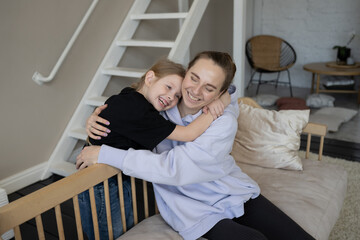 A happy family, a mother and a schoolgirl daughter hug. Mother's Day.