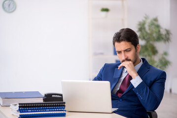 Young male employee working at workplace