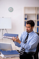 Young male employee working in the office