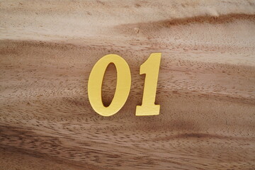 Golden Arabic numerals on a real brown and white wooden floor number 02