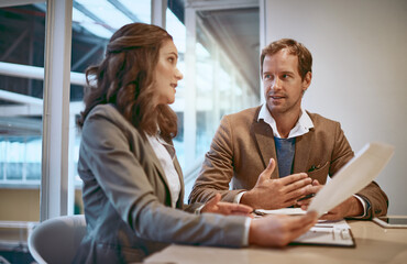 Proofreading his paperwork. Cropped shot of two businesspeople working together in the boardroom.
