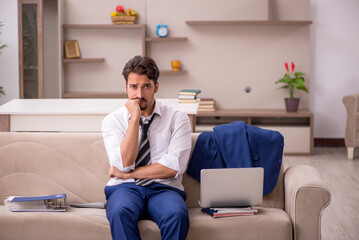 Young male employee working from home during pandemic