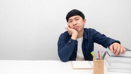 Man gesture bored to working and reading book on the table copy space
