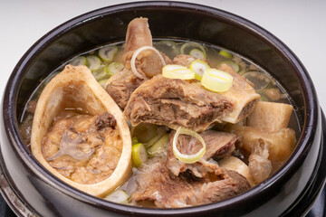 Beef bone marrow soup or Seolleongtang in hot iron pot, Beef Stock Bone, Marrowbone soup in hot iron pot Korean traditional food.