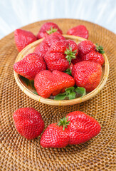 Red strawberries on wooden bowl in wooden background, Fresh Amaoh Strawberry  on wooden plate background.