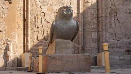 Granite sculpture of a falcon in the ancient temple of Horus in Edfu. There is damage on the...