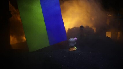 The death of children in the war. Russian war in Ukraine concept. Creative artwork of little doll lies on ground in burned out city. Selective focus