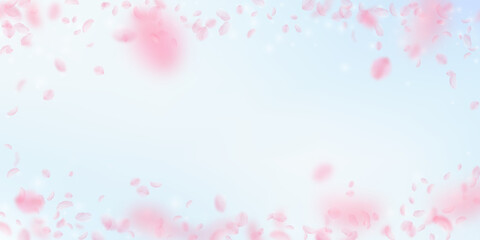 Sakura petals falling down. Romantic pink flowers vignette. Flying petals on blue sky wide background. Love, romance concept. Original wedding invitation.