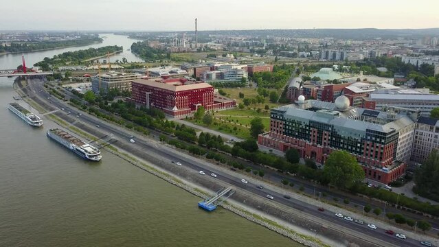 Cinematic 4K aerial drone pan shot of L&aacute;gym&aacute;nyosi ELTE Campus Southern Block, University of Technology and Economics, Kopaszi-g&aacute;t by the Danube river in Budapest, Hungary