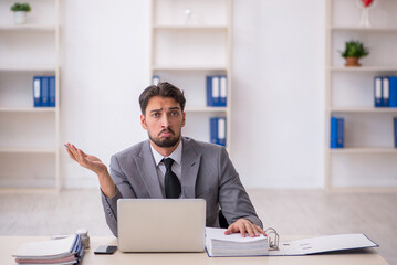 Young male employee working in the office