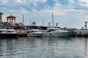 White pleasure boats moored in the sea port.