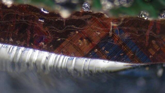 CPU layers, 100x times magnification. Internal structure of a modern processor. Sparkling silicon and lithography macrotexture. Nanoscale transistors. Solder. Computer processor under microscope