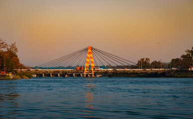 Fototapeta na wymiar isolated cable bridge over ganges river with colorful sky at evening