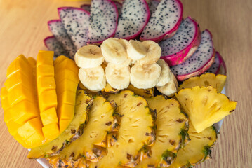 Vietnamese asia fruits: pineaple, banana, dragon fruit, mango. Fresh, jucie and very tasty.