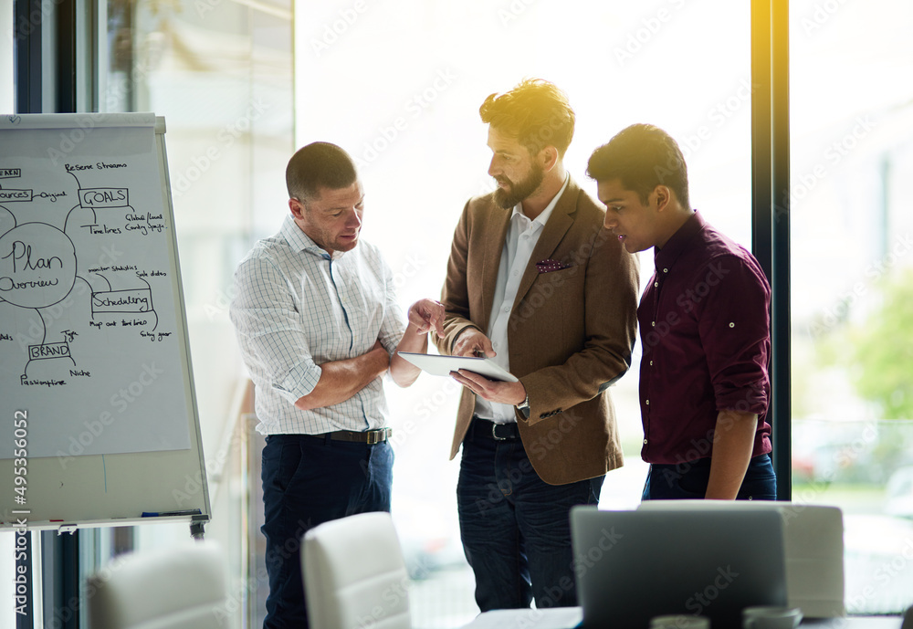 Poster sharing the latest updates together. cropped shot of a group of colleagues having a discussion in an
