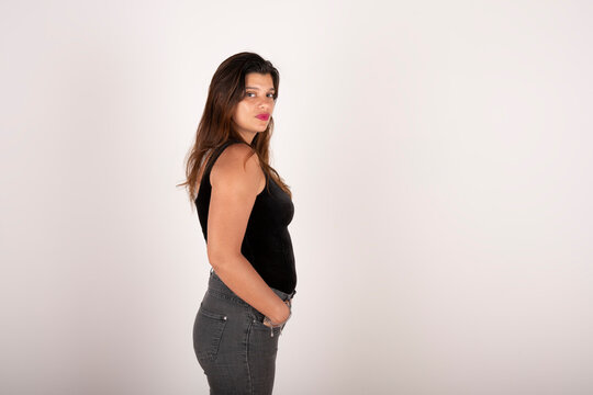 Portrait Of A Young Latin Woman In Profile On White Background