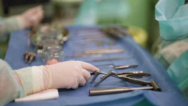 Close-up of sterile surgical instruments for laparoscopic surgery. Action. Instruments for medical surgery, the concept of health and medicine.
