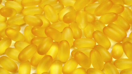 Organic supplements vitamins yellow capsules Omega 3 or D-3 pills, macro shot. Dietary supplement, close up
