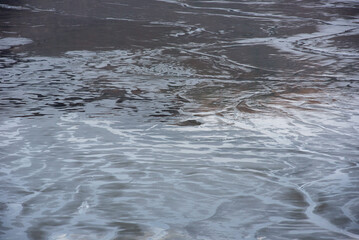 Muddy waters in a decantation pond. Toxic residuals from a copper mine decating in a settling basin