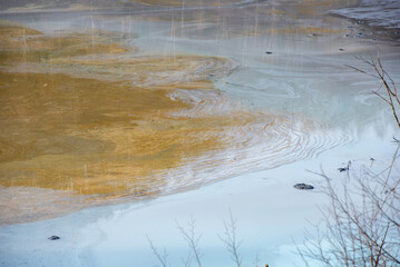 Muddy waters in a decantation pond. Toxic residuals from a copper mine decating in a settling basin
