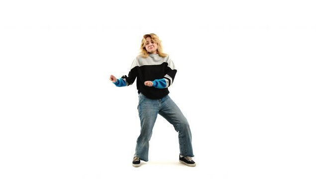 Teenage caucasian girl in  90s style casual clothes hip hop dancing, white studio background